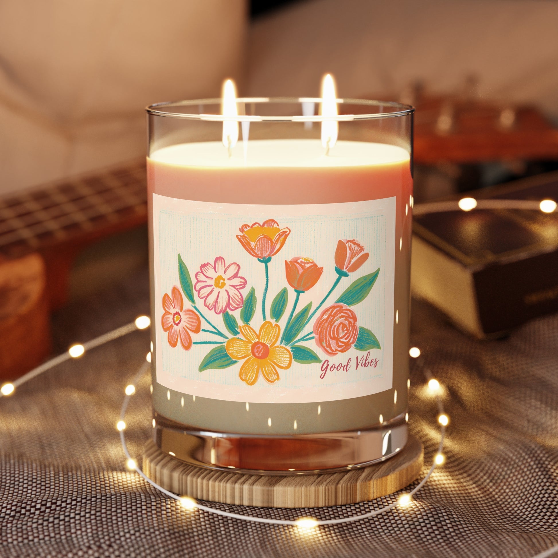 11 oz artisan-made, 100 % vegan soy wax candle with two cotton-cored whicks. It features a vibrant floral print and Good Vibes calligraphy. 