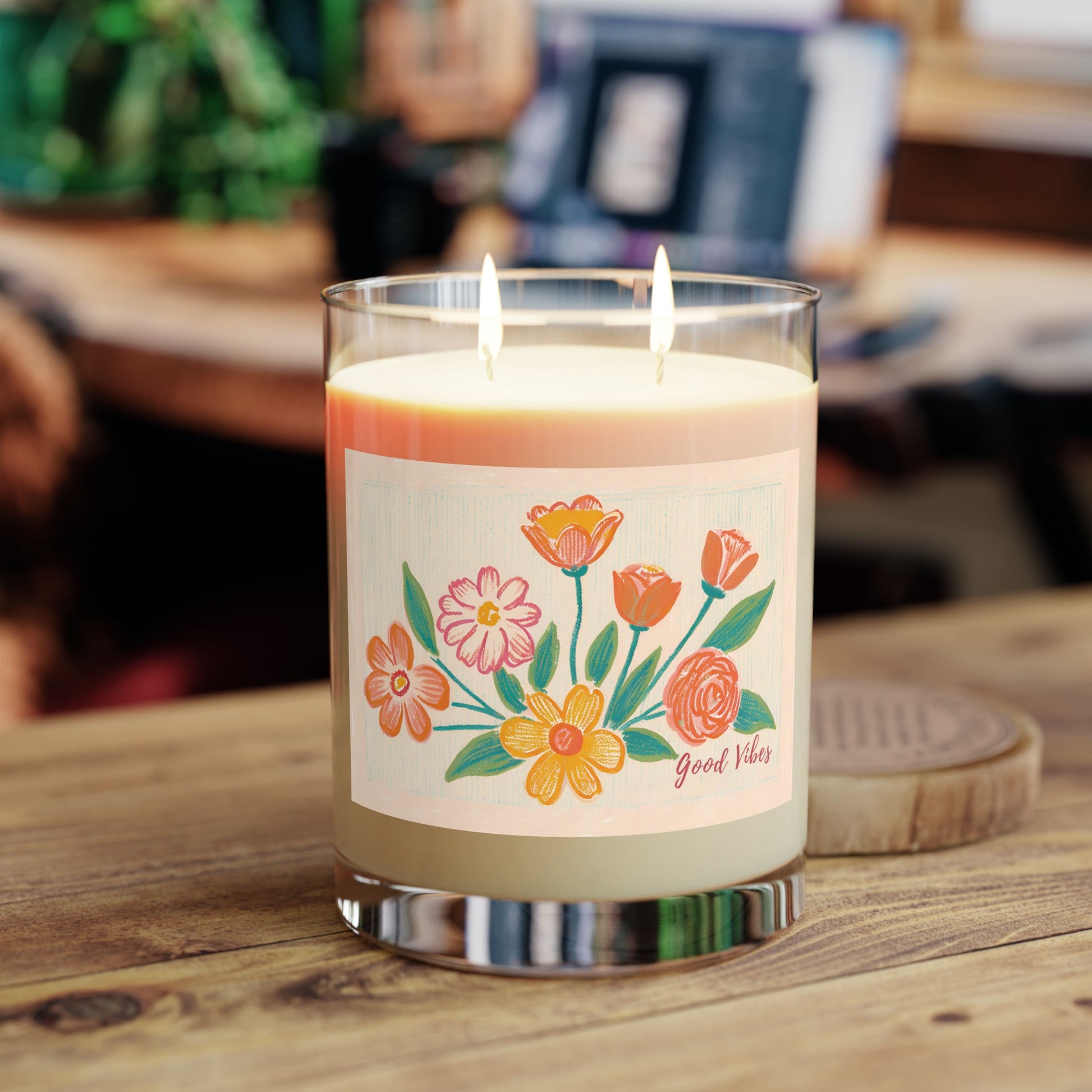11 oz eco-friendly 100 % vegan soy wax candle with two cotton-cored whicks, a reusable glass jar and cardboard lid. It features a floral color pencil floral print and Good Vibes typography. 