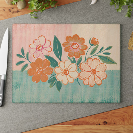 tempered Glass Cutting Board with flowers motif set over a plaid backdrop in pastel colors.